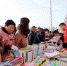 4月23日，博湖县开展世界读书日“书香博湖 全民阅读”流动售书活动，图为活动现场村民们争相观看购买书籍。海潮 摄 - 人民网