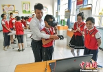 6月14日，新疆喀什地区疏附县托克扎克镇中心小学，学生们在科技教室内体验VR模拟器。 中新社记者 刘新 摄 - 中国新疆网